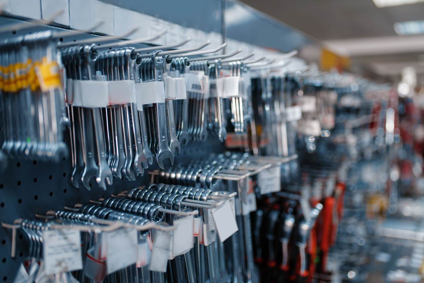 Wrenches and hand tools organised on a hardware store wall